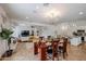 Open-concept dining and living area with a modern chandelier and stylish furnishings at 9015 E Altadena Ave, Scottsdale, AZ 85260