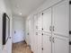 Hallway featuring a wall of built-in cabinets and a door at 9015 E Altadena Ave, Scottsdale, AZ 85260