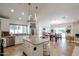 Open-concept kitchen with granite counters, stainless appliances, and a center island at 9015 E Altadena Ave, Scottsdale, AZ 85260