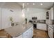 Bright kitchen with white cabinets, stainless appliances, and a center island with seating at 9015 E Altadena Ave, Scottsdale, AZ 85260