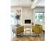 Bright living room featuring a modern fireplace, stylish chairs, and ample natural light at 9015 E Altadena Ave, Scottsdale, AZ 85260