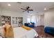 Bright bedroom featuring hardwood floors, ceiling fan, and a comfortable blue sofa, creating a cozy atmosphere at 9015 E Altadena Ave, Scottsdale, AZ 85260