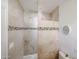 Walk-in shower featuring stone accents and tile flooring at 9015 E Altadena Ave, Scottsdale, AZ 85260