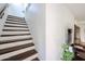 Stairway with dark wood treads and risers, leading to the upper levels of the home at 9015 E Altadena Ave, Scottsdale, AZ 85260