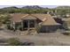 Aerial view of the home showcasing arches, tile roof and desert landscaping at 9690 W Martin Rd, Casa Grande, AZ 85194