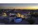 Backyard aerial view displaying a pool, covered patio, and mature landscaping at dusk at 9690 W Martin Rd, Casa Grande, AZ 85194