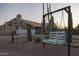 Scenic backyard with a charming swing set, desert plants, and a view of the home at 9690 W Martin Rd, Casa Grande, AZ 85194
