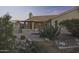 Exterior backyard view highlighting a covered patio, desert landscaping, and a wooden bridge feature at 9690 W Martin Rd, Casa Grande, AZ 85194