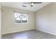Cozy bedroom with a ceiling fan, large window, and tile floors, perfect for relaxation at 9690 W Martin Rd, Casa Grande, AZ 85194