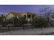 Desert home with an arched entryway, and wood fence creates a picturesque, inviting scene at 9690 W Martin Rd, Casa Grande, AZ 85194