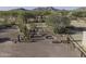 Tranquil outdoor area with a fire pit, swing, desert landscaping, and a charming wooden fence at 9690 W Martin Rd, Casa Grande, AZ 85194