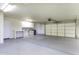 A clean and spacious garage featuring epoxy floors, workbench, and ample storage cabinets at 9690 W Martin Rd, Casa Grande, AZ 85194