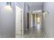 Bright hallway featuring tile flooring and neutral wall color, connecting various rooms of the house at 9690 W Martin Rd, Casa Grande, AZ 85194