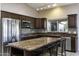 Kitchen boasts granite countertops, stainless appliances and breakfast bar at 9690 W Martin Rd, Casa Grande, AZ 85194
