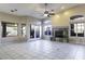 Spacious living room with vaulted ceilings, fireplace, tile flooring, and multiple windows at 9690 W Martin Rd, Casa Grande, AZ 85194