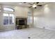 Living room featuring stone fireplace, tile flooring, vaulted ceiling, and natural light at 9690 W Martin Rd, Casa Grande, AZ 85194