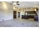 Open concept: kitchen with stainless steel appliances flows into a large living area with vaulted ceilings at 9690 W Martin Rd, Casa Grande, AZ 85194
