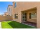 Spacious backyard with lush faux grass, patio, and block wall perfect for entertaining at 1564 W Redwood Ln, Phoenix, AZ 85045