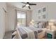 Well-lit bedroom featuring neutral decor, a modern ceiling fan, and a comfortable bed at 1564 W Redwood Ln, Phoenix, AZ 85045