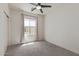 Bright bedroom with neutral walls, plush carpet, and a modern ceiling fan at 1564 W Redwood Ln, Phoenix, AZ 85045