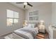 Bedroom with neutral walls, ceiling fan, and bed accented with decorative pillows at 1564 W Redwood Ln, Phoenix, AZ 85045