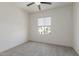 Bright bedroom with neutral walls, plush carpet, and large window at 1564 W Redwood Ln, Phoenix, AZ 85045