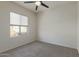 Bright bedroom with neutral walls, plush carpet, and large window at 1564 W Redwood Ln, Phoenix, AZ 85045