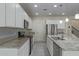 Modern kitchen featuring white cabinetry, stainless steel appliances, granite countertops, and an island sink at 1564 W Redwood Ln, Phoenix, AZ 85045