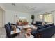 Bright living room boasts modern furnishings, a stylish ceiling fan, and large windows for ample natural light at 1564 W Redwood Ln, Phoenix, AZ 85045