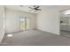 Bright main bedroom with neutral carpet, ceiling fan, and access to balcony at 1564 W Redwood Ln, Phoenix, AZ 85045