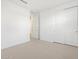 Bedroom with neutral carpet, white walls, and a closet with sliding doors at 16084 W Prickly Pear Trl, Surprise, AZ 85387