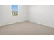 Bedroom with window, neutral carpet, white walls, and two electrical outlets at 16084 W Prickly Pear Trl, Surprise, AZ 85387