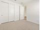 Bright bedroom with ample closet space and an open doorway to another room at 16084 W Prickly Pear Trl, Surprise, AZ 85387