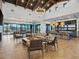 Spacious clubhouse with modern finishes, ample seating, a large bar, and access to outdoor amenities at 16084 W Prickly Pear Trl, Surprise, AZ 85387