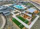 Aerial view of community amenities showcasing a pool, splash pad, playground, bbq, and cornhole area at 16084 W Prickly Pear Trl, Surprise, AZ 85387