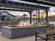 Relaxing fire pit area with comfortable seating and views of the community pool at 16084 W Prickly Pear Trl, Surprise, AZ 85387