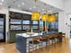 Modern kitchen featuring a large island, pendant lighting, and a view of the outdoor grilling area through a large window at 16084 W Prickly Pear Trl, Surprise, AZ 85387