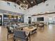 Spacious living room featuring wood beam ceilings, modern furniture, and an open floor plan, creating an inviting and bright atmosphere at 16084 W Prickly Pear Trl, Surprise, AZ 85387