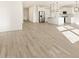 Open-concept living area with a modern kitchen featuring stainless steel appliances and bright white cabinets at 16084 W Prickly Pear Trl, Surprise, AZ 85387