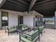 Relaxing patio featuring comfortable outdoor seating, a stylish chandelier, and views of the community pool at 16084 W Prickly Pear Trl, Surprise, AZ 85387