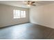 Bedroom with ceiling fan and a view of a building from the window at 7960 E Camelback Rd # 110, Scottsdale, AZ 85251