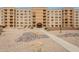Multi-level condo building featuring balconies, desert landscaping, and covered entry at 7960 E Camelback Rd # 110, Scottsdale, AZ 85251
