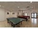 Bright game room with pool tables, ping pong, tile flooring, and recreational space at 7960 E Camelback Rd # 110, Scottsdale, AZ 85251