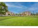 Well-manicured golf course with lush green grass, yellow flag, and residential buildings in the background at 7960 E Camelback Rd # 110, Scottsdale, AZ 85251