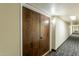 Hallway with wall mounted lighting and neutral carpet at 7960 E Camelback Rd # 110, Scottsdale, AZ 85251