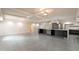 Bright kitchen with a large island, modern lighting, stainless steel appliances, and gray tile flooring at 7960 E Camelback Rd # 110, Scottsdale, AZ 85251