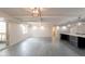 Spacious open-concept kitchen and dining area with modern lighting, gray tile floors, and ample space at 7960 E Camelback Rd # 110, Scottsdale, AZ 85251
