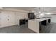 Modern kitchen features a large island, stainless appliances, gray tile flooring, and contemporary lighting at 7960 E Camelback Rd # 110, Scottsdale, AZ 85251