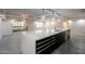 Modern kitchen with a large island, stainless steel appliances, and balcony access, and gray tile flooring at 7960 E Camelback Rd # 110, Scottsdale, AZ 85251