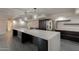 Spacious kitchen features a large island, stainless appliances, and modern lighting and gray tile flooring at 7960 E Camelback Rd # 110, Scottsdale, AZ 85251
